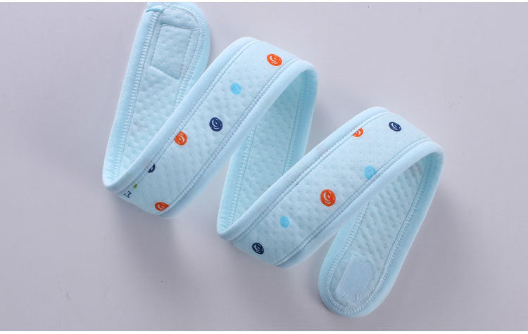 Light blue adorable bear baby quilt with colorful smiley face patterns folded on gray background