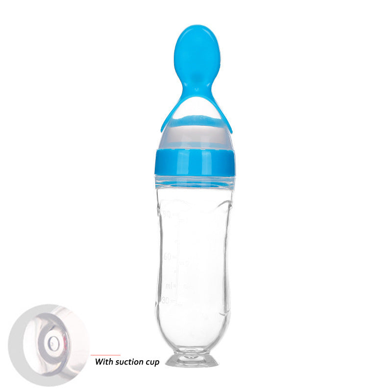 Clear baby food supplement feeder with blue spoon cap and suction cup base for easy feeding