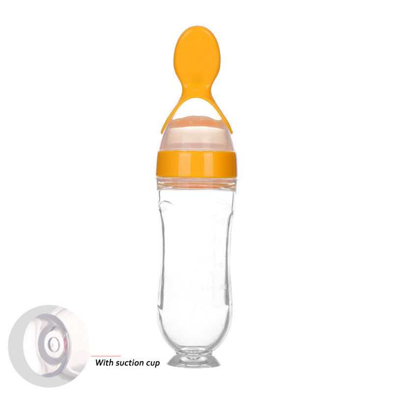 Clear baby food supplement feeder with orange spoon and suction cup base for easy feeding