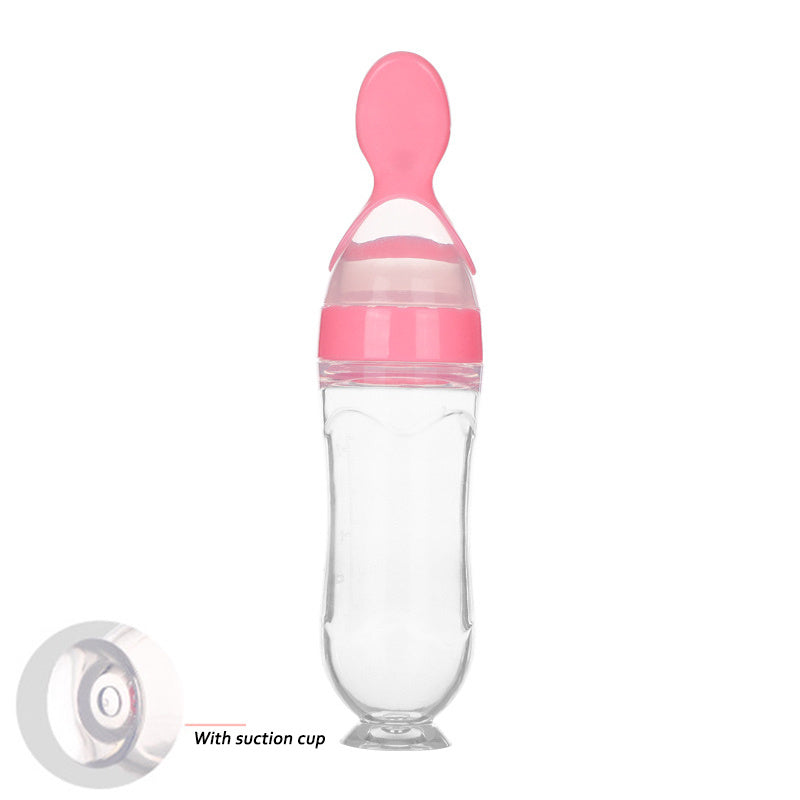 Clear baby food supplement feeder with pink spoon and suction cup base for easy feeding