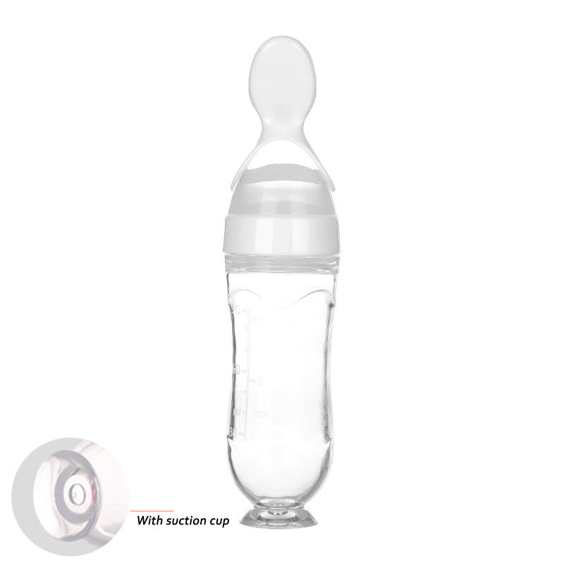 Clear baby food supplement feeder with soft spoon tip and suction cup base for easy feeding