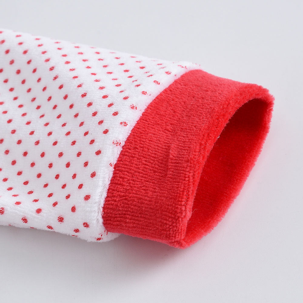 Close-up of red and white sleeve cuff on a soft Christmas baby onesie with polka dots