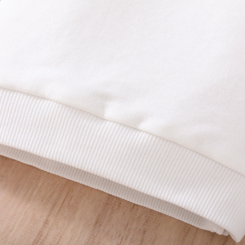 Close-up of white ribbed cuff on cute baby plaid sweatshirt fabric showing soft texture