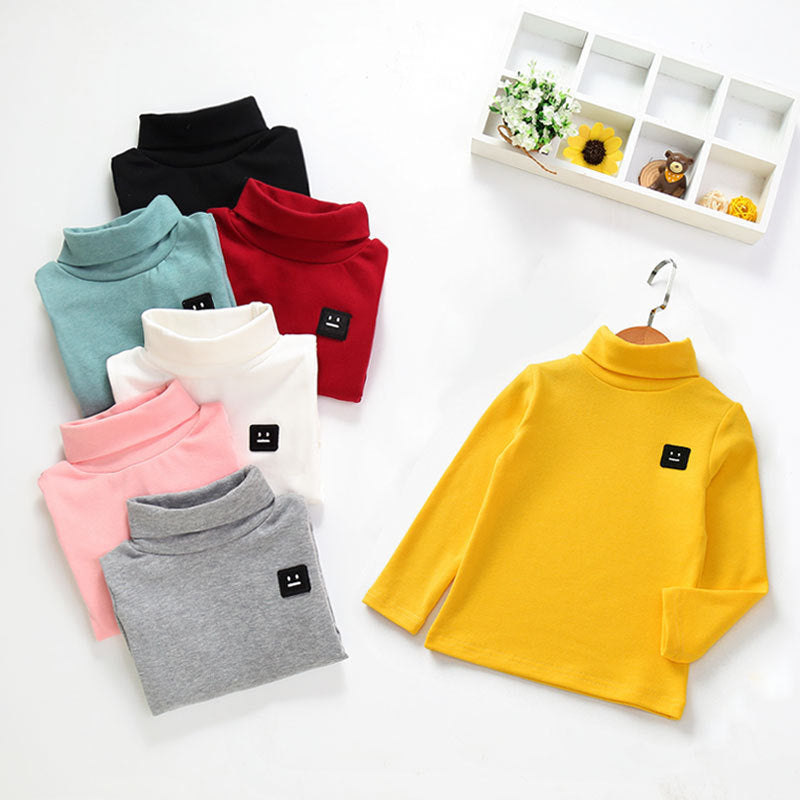 Colorful cotton tops for toddlers in yellow, black, red, teal, white, pink, and gray with long sleeves and turtlenecks