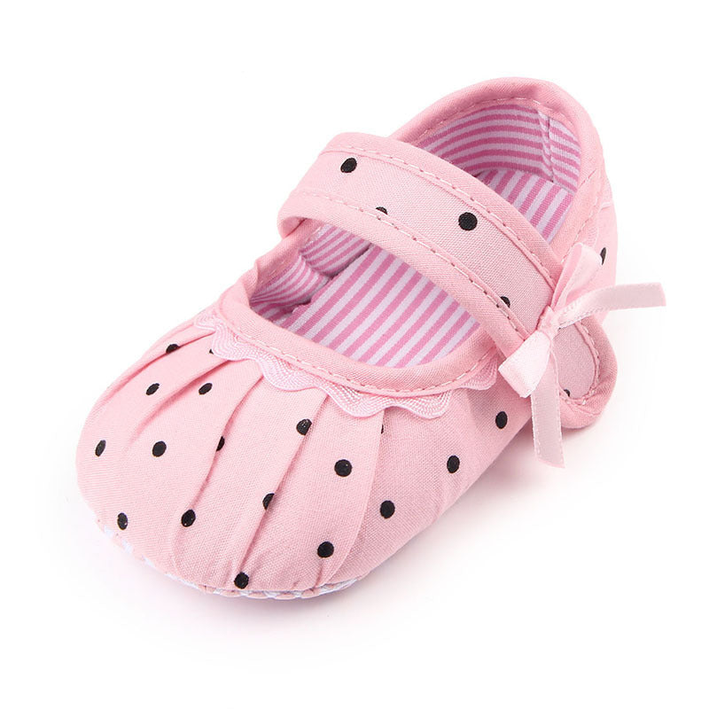Cute pink polka dot baby shoe with strap and bow featuring striped inner lining cute princess baby shoes