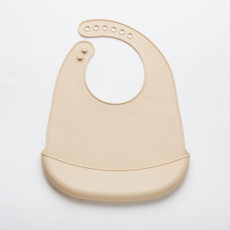 Beige easy clean baby eating bib with adjustable neck closure and food catch pocket