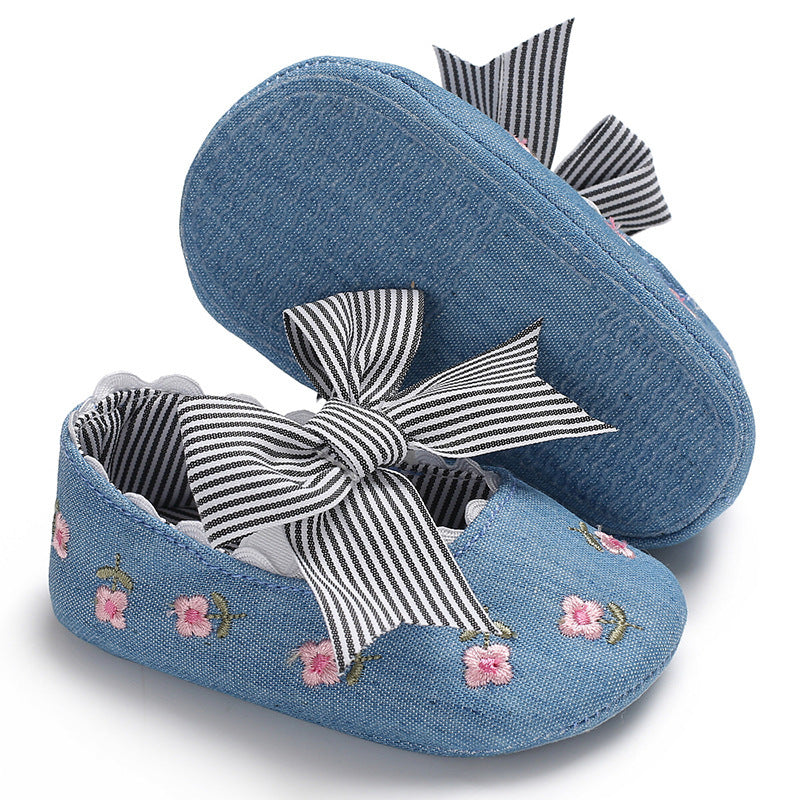 Blue floral crib shoes for girls with pink flower embroidery and striped bow accents