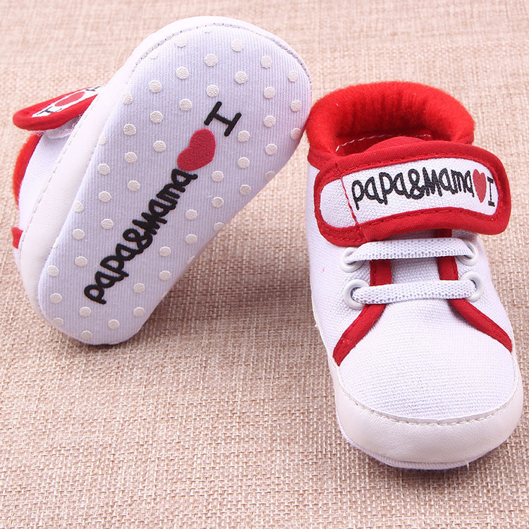 White and red baby shoes with I love mom and dad baby shoes text and heart design