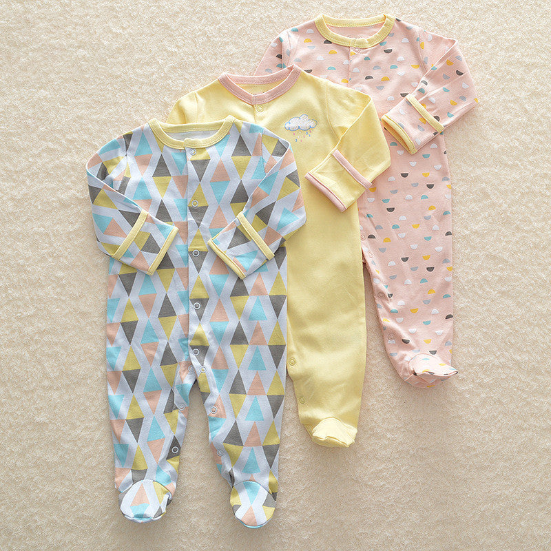 Set of three colorful long sleeve baby onesie with geometric and cloud patterns on soft fabric