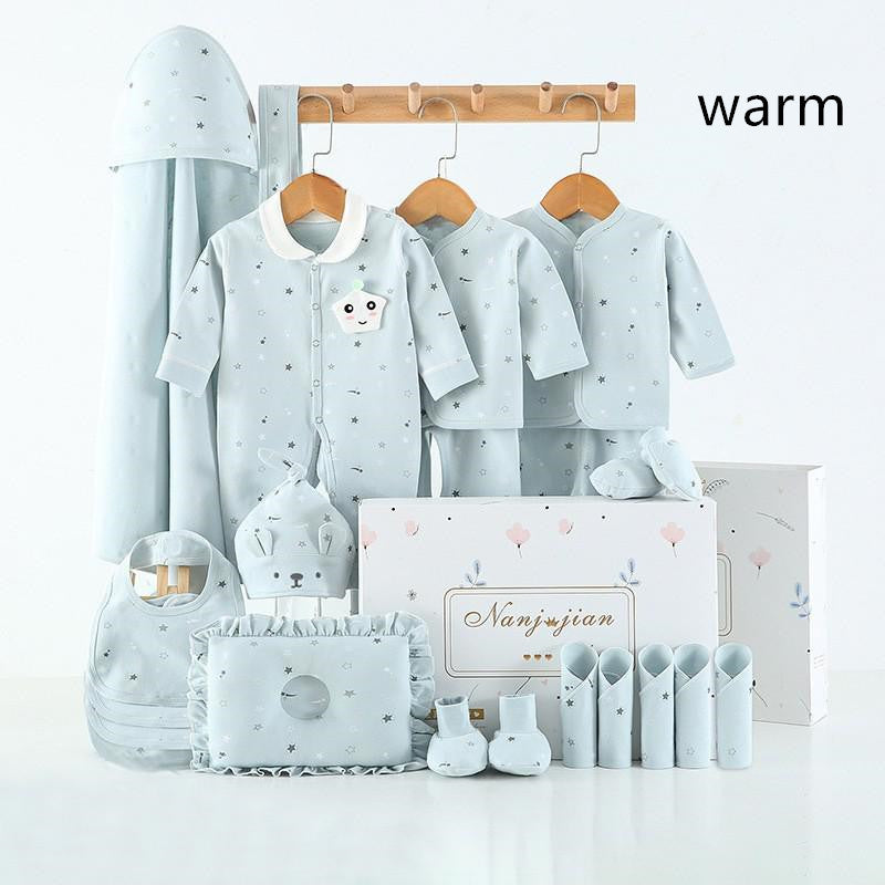 Newborn baby clothes gift set in light blue with star patterns including bodysuit, hats, mittens, and bib