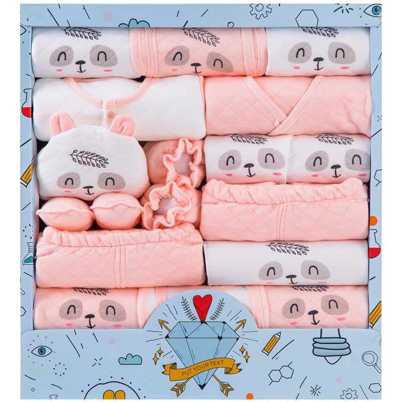 Newborn gift box with soft pink and white baby clothes featuring cute animal faces and matching booties