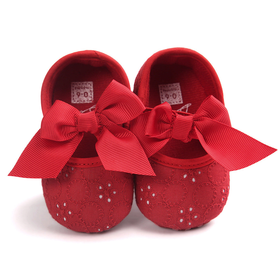 Pink baby shoes with bow featuring floral embroidery and large decorative ribbons