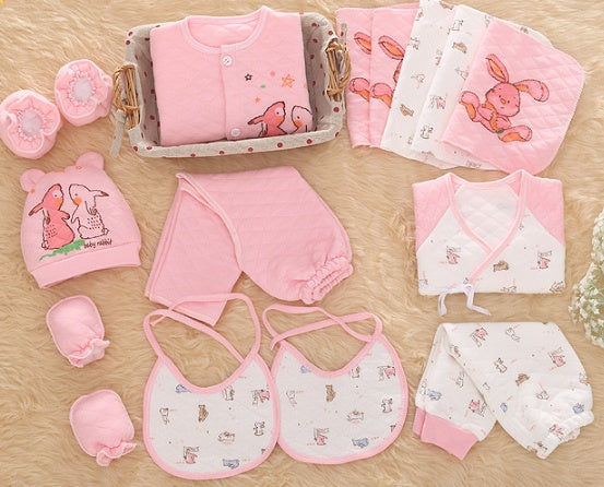 Gift box with warm newborn outfits for winter in pink including mittens, hat, bibs, pants, and quilted clothes