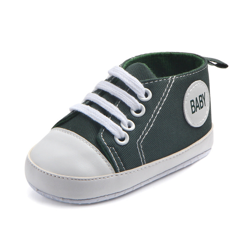 Green and white soft sole baby sneakers with laces and BABY patch on the side