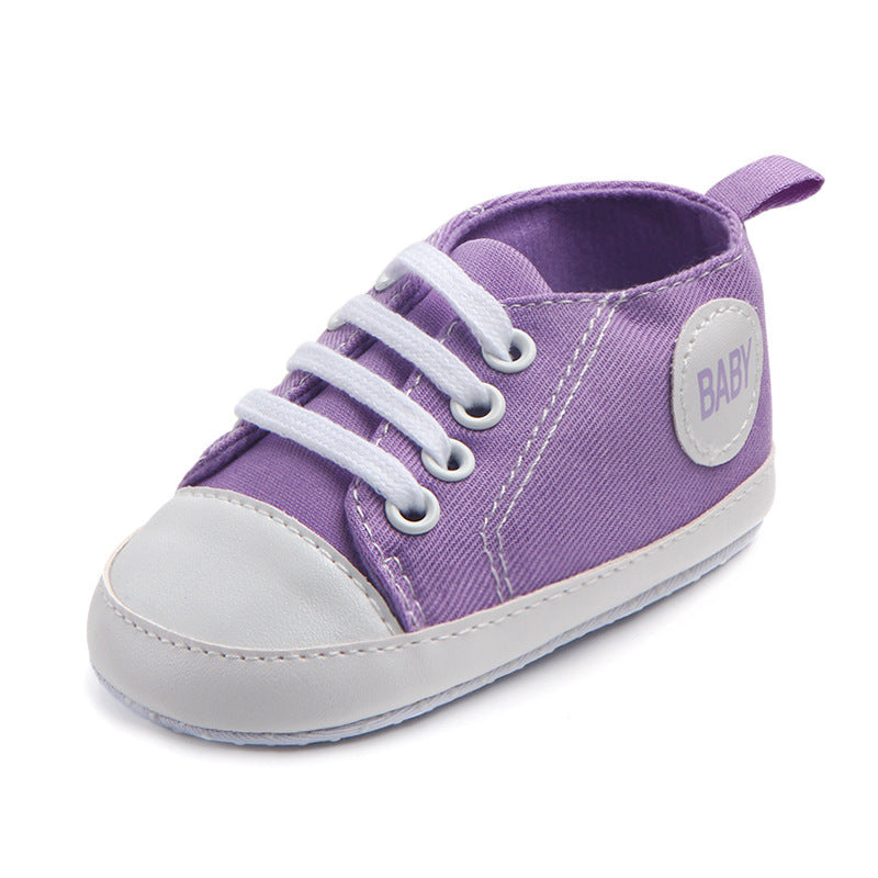 Purple soft sole baby sneakers with white laces and toe cap for comfortable infant wear