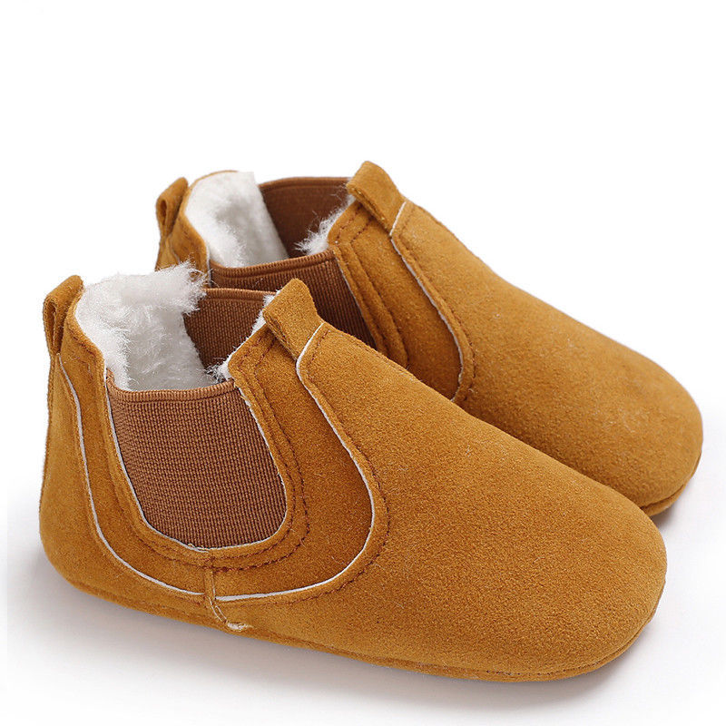 Brown soft sole infant shoes with elastic sides and plush white lining for comfort
