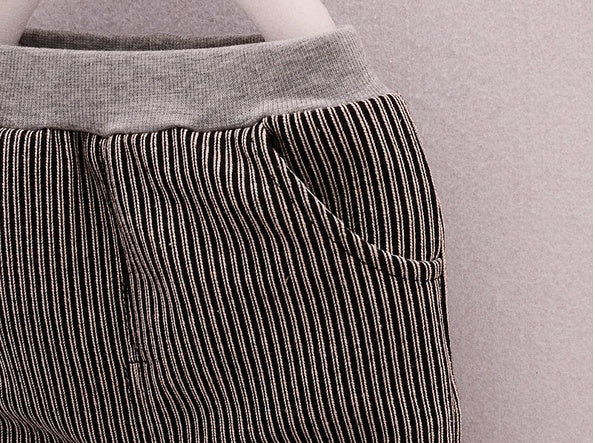 Close-up of striped fabric pocket and gray waistband on unisex toddler casual suit pants