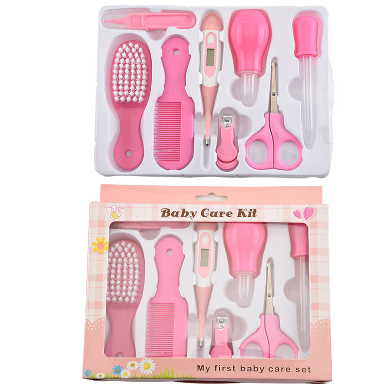 Complete baby grooming set with pink brush, comb, thermometer, scissors, nail clippers, and other baby care tools