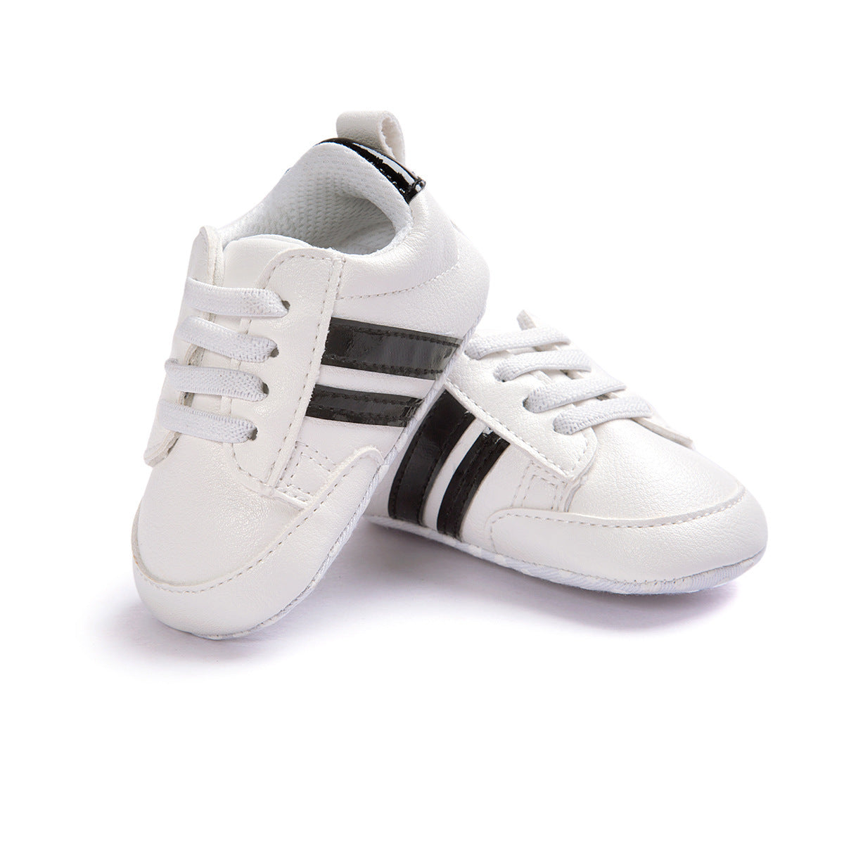 White infant moccasin shoes with black stripes and lace-up design for babies