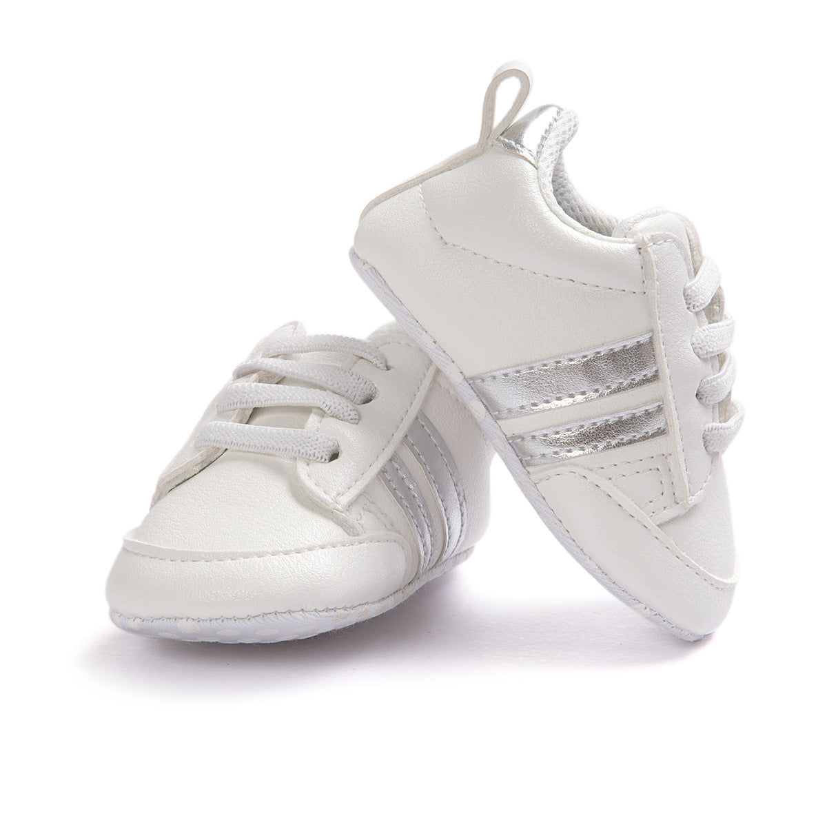 White infant moccasin shoes with silver stripes and laces for babies