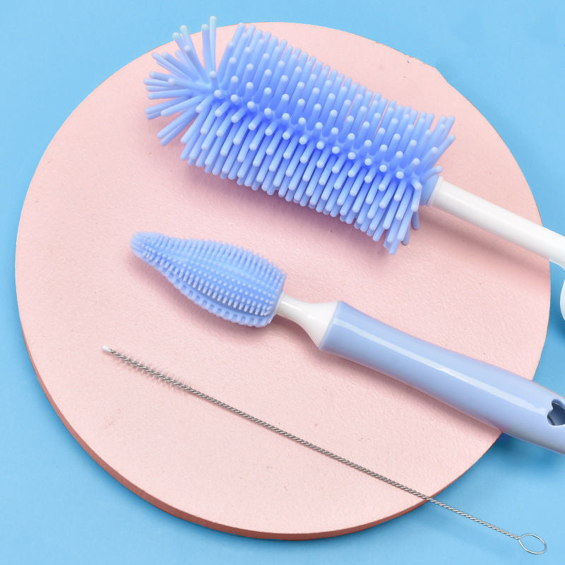 Blue baby bottle cleaning brush set with multiple brushes for thorough cleaning on pink and blue background