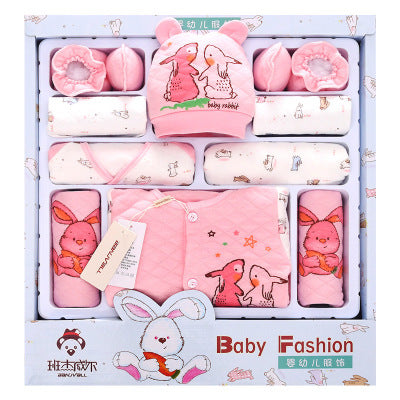 Gift box containing warm newborn outfits for winter in pink with bunny designs including hat, mittens, and blankets