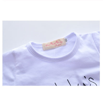 Close-up of white baby girl clothes set with round neckline and soft fabric