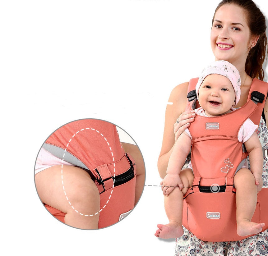 Smiling mom carrying happy baby in coral best baby carrier for moms with secure straps and comfortable design