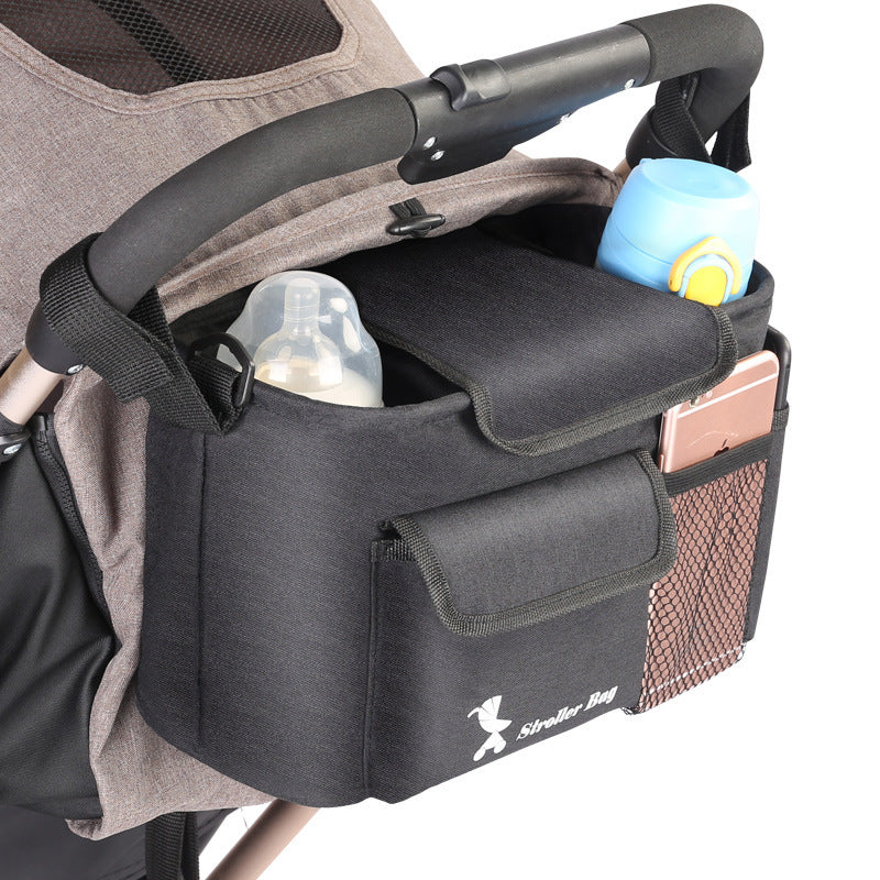 Black baby essentials organizer for stroller attached to stroller handle with bottles and phone