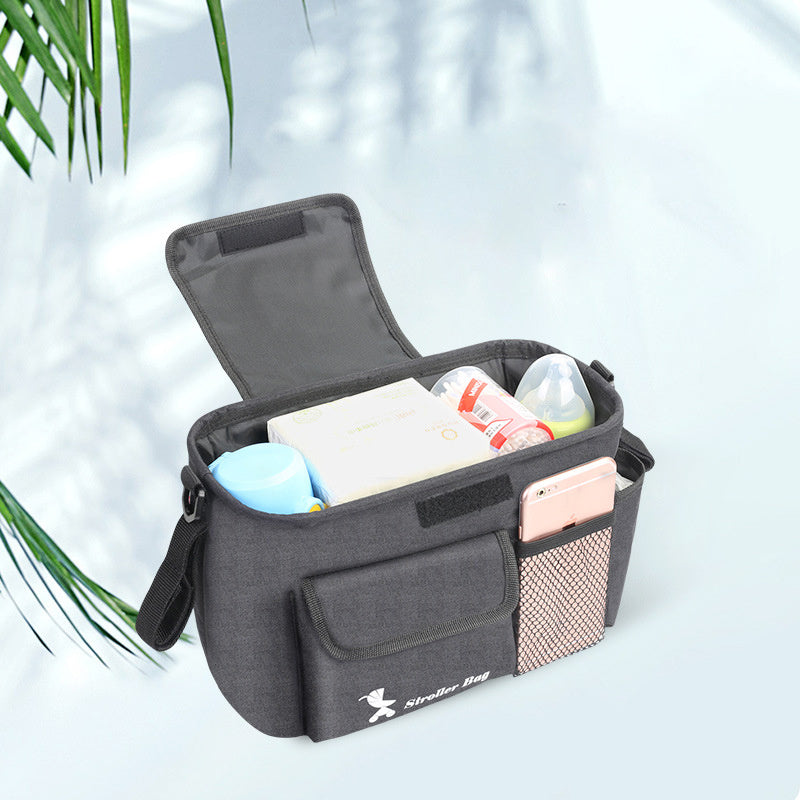 Gray baby essentials organizer for stroller with multiple compartments holding bottles and baby wipes