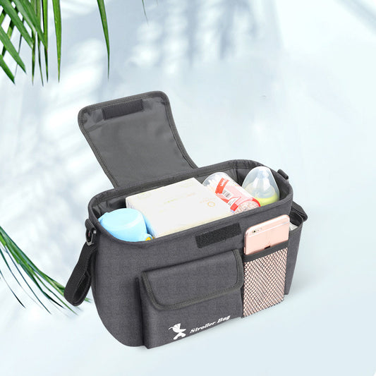 Gray baby essentials organizer for stroller with multiple compartments holding bottles and baby wipes