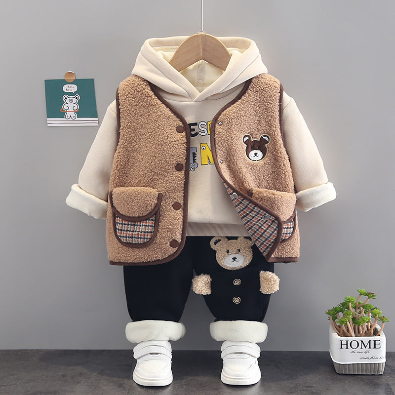 Warm toddler clothes set featuring a beige hoodie, brown fuzzy vest with bear patch, black pants with bear details, and white shoes
