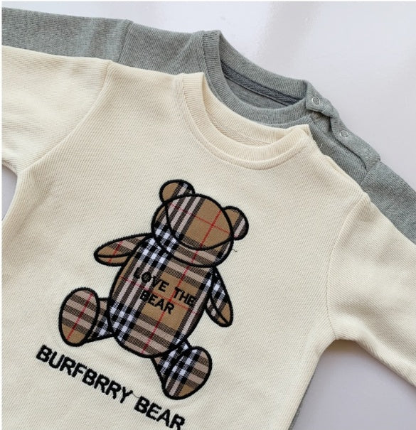 Trendy baby onesies for boys featuring a plaid bear design in cream and gray colors