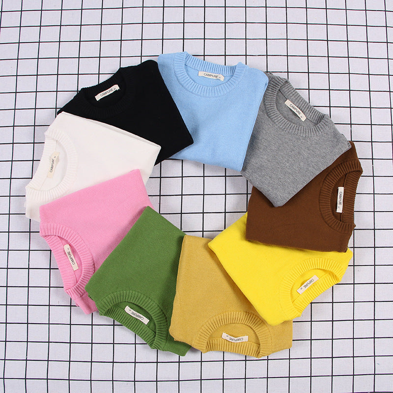 Circle arrangement of solid color toddler sweater in various colors including blue pink green yellow and brown