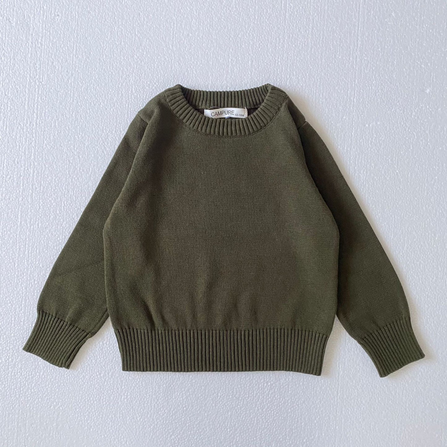 Solid color toddler sweater in olive green with ribbed cuffs and hem for comfortable wear
