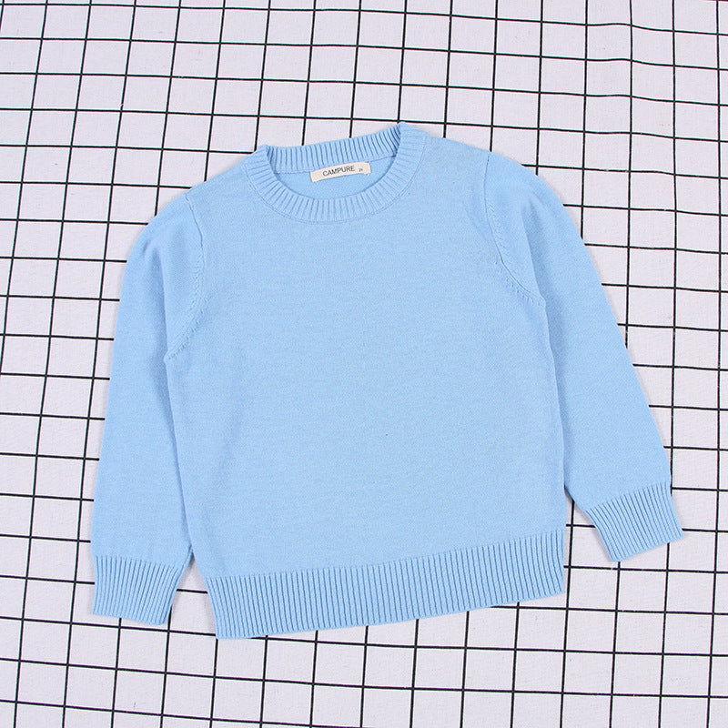 Light blue solid color toddler sweater with ribbed cuffs and hem on grid background