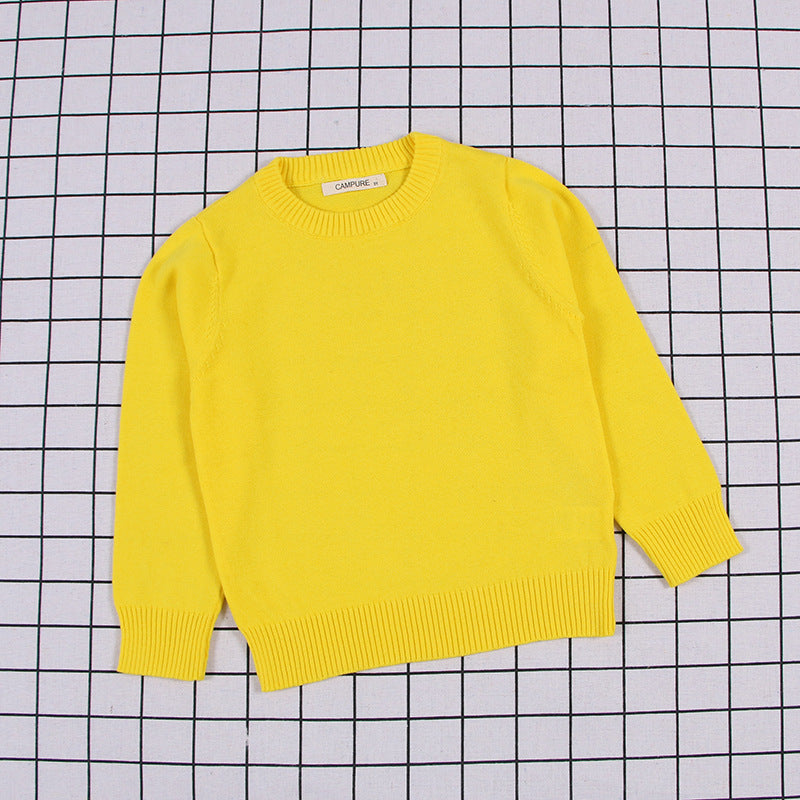 Bright yellow solid color toddler sweater with long sleeves and ribbed cuffs