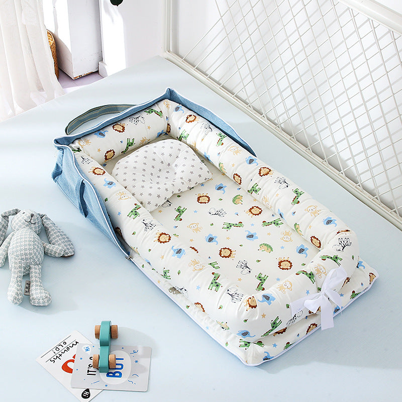 Portable baby travel crib with soft animal print cushioning and matching pillow for infants