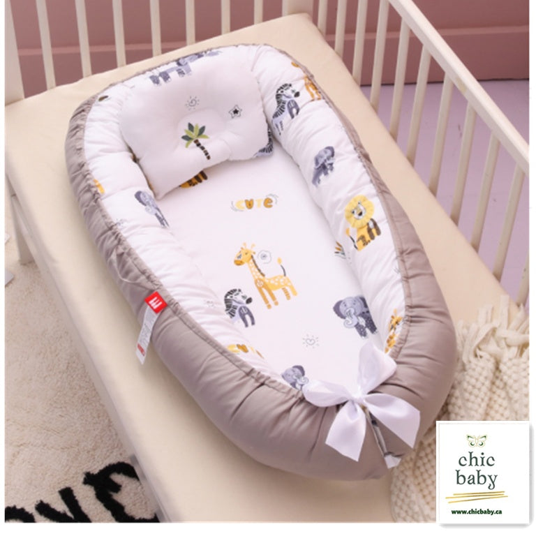 Portable baby travel crib with animal print and cushioned beige sides for comfortable infant rest