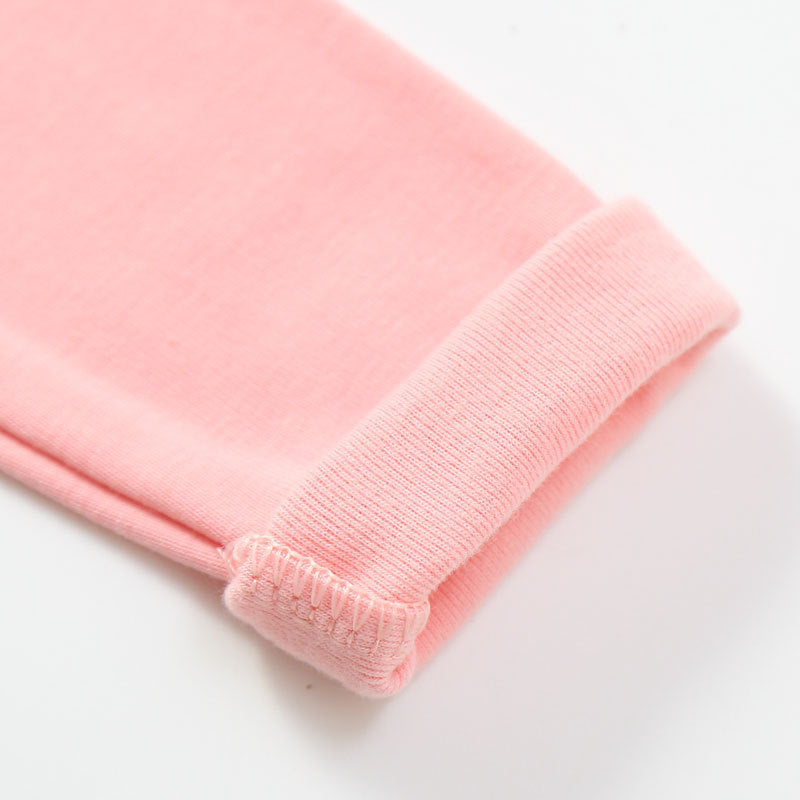 Close-up of soft pink fabric cuff from cotton tops for toddlers showing detailed stitching