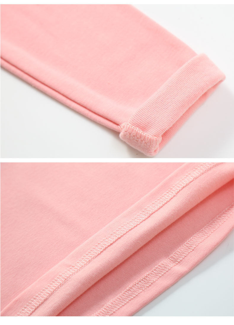 Close-up details of soft pink cotton tops for toddlers showing fabric texture and stitching