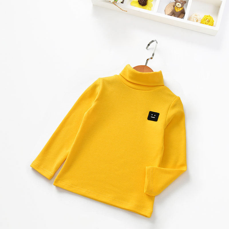 Yellow cotton tops for toddlers with long sleeves and a turtleneck design on a hanger