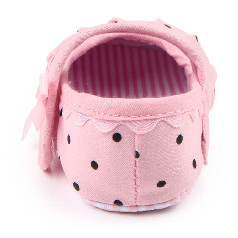 Pink polka dot cute princess baby shoes with scalloped trim and bow detail