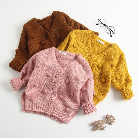 Cute toddler cardigan for girls in pink, mustard yellow, and brown with pom pom details