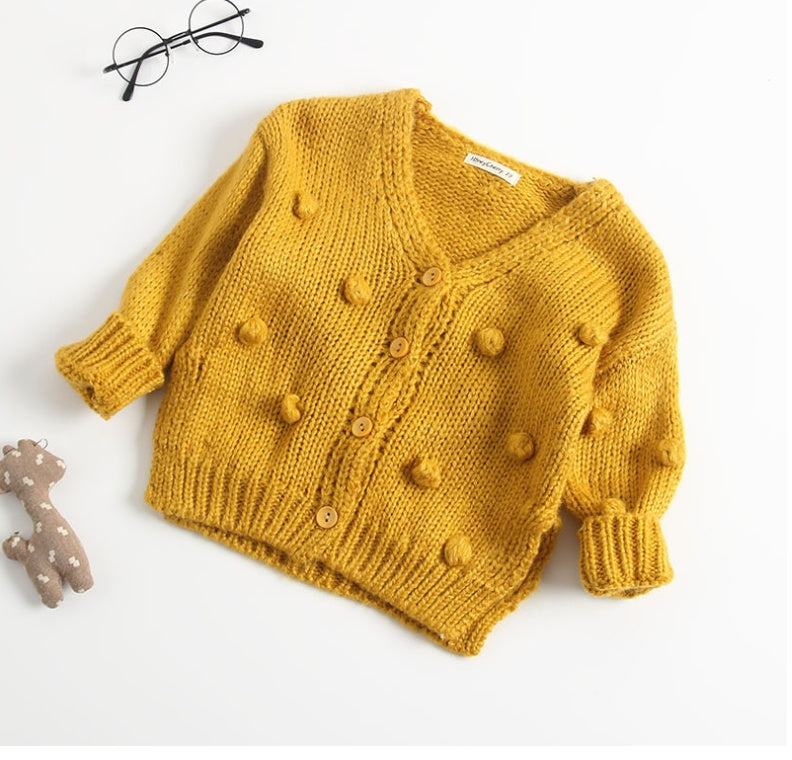 Mustard yellow knitted cute toddler cardigan for girls with button front and textured pom-pom details