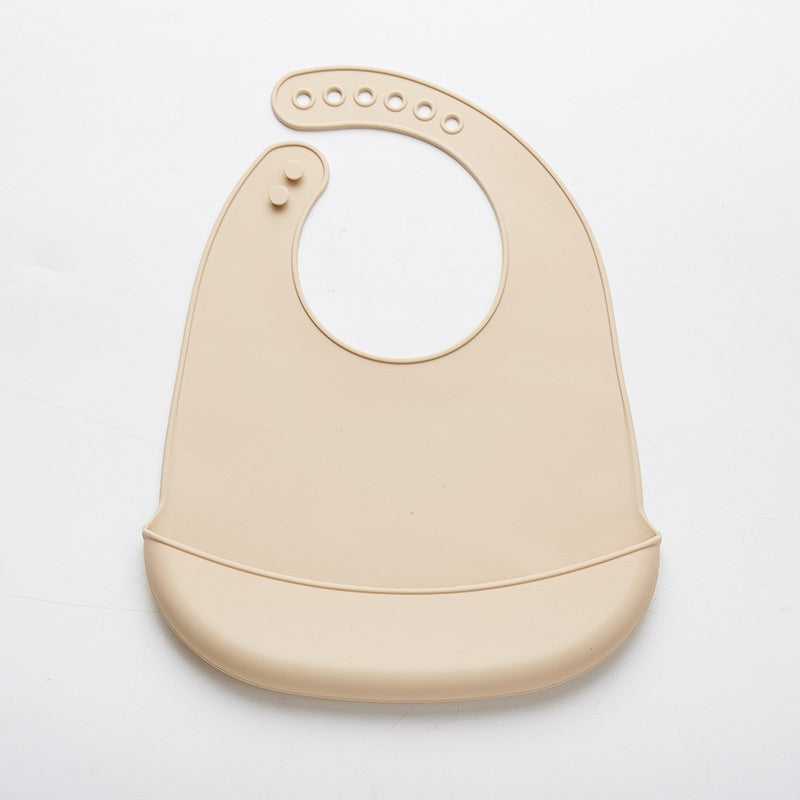 Beige easy clean baby eating bib with adjustable neck strap and food-catching pocket