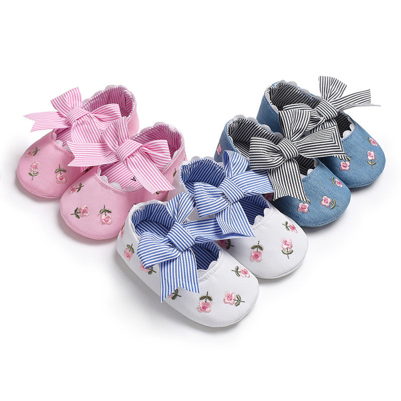 Set of pink white and blue floral crib shoes for girls with striped bow accents
