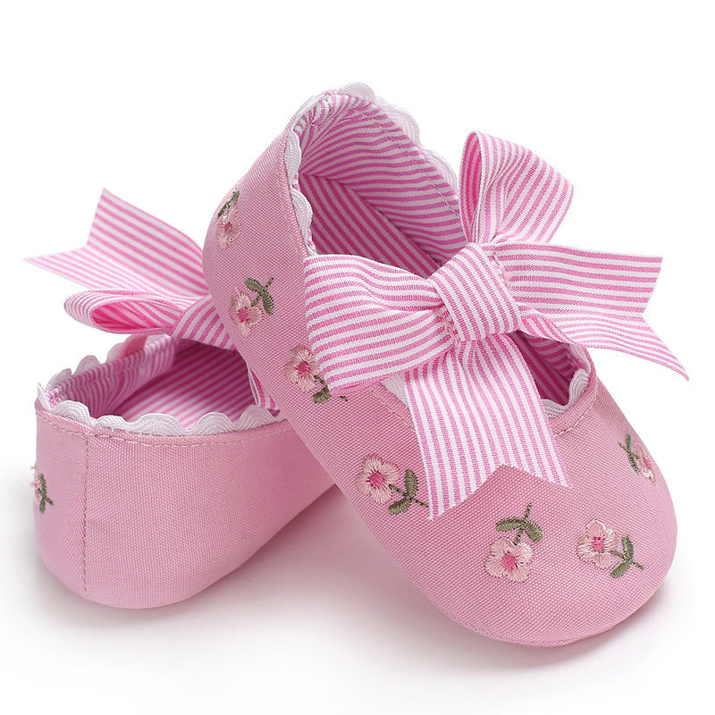 Pink floral crib shoes for girls with embroidered flowers and striped bow detail