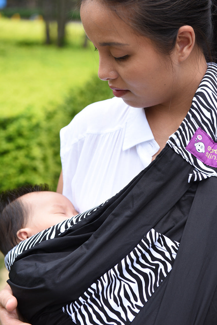 Mother carrying sleeping baby in a lightweight baby carrier bag with zebra print details