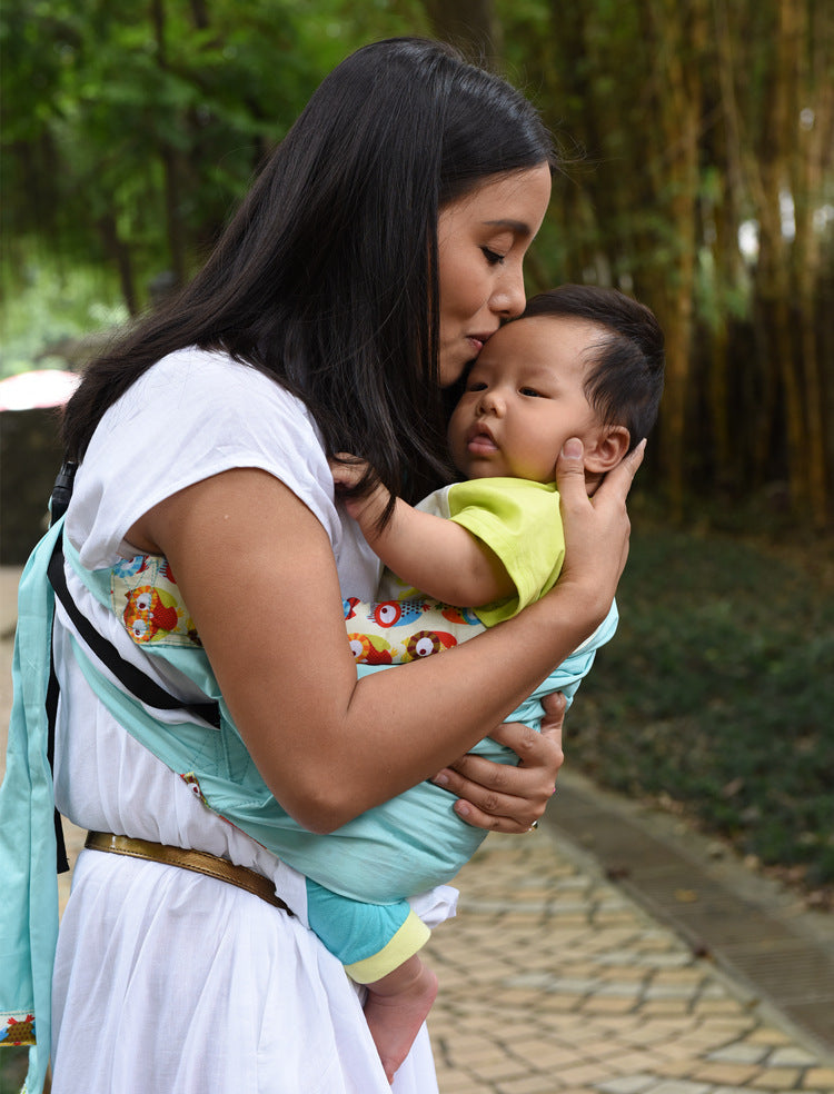 Mother carrying baby in a lightweight baby carrier bag outdoors with comfortable support